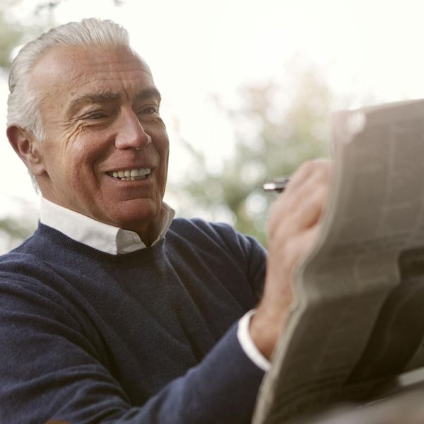 Person enjoying a vibrant natural landscape with clear focus and a smile.